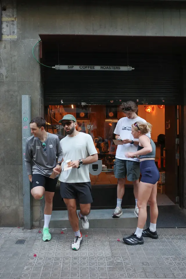 A small group of runners standing outside a doorway