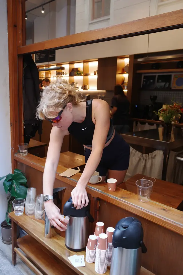 A person leaning on a cafe counter
