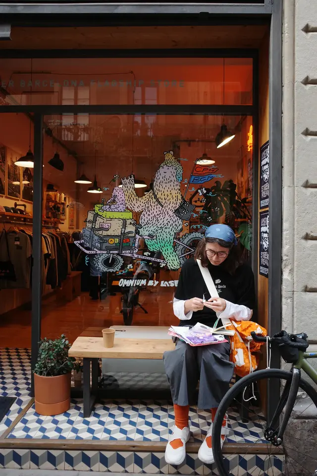 A group of people gathered in a shop doorway, seen from above